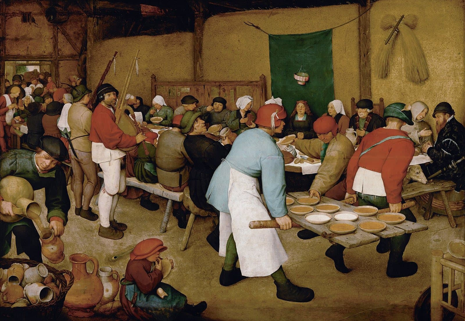 Crowded painting of a village wedding feast in a barn: guests at a long table, the bride seated beneath a green cloth, men carrying bowls of porridge on a door, a piper playing