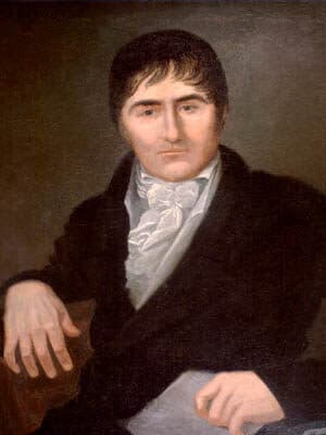 Oil portrait of a dark-haired man in a black coat and high white cravat, seated with one hand resting on the arm of his chair